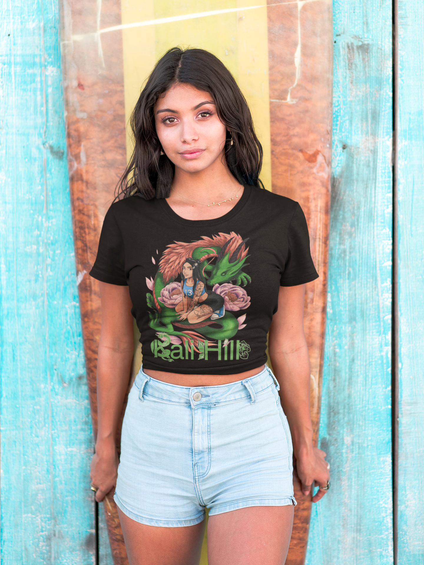 hispanic-girl-wearing-a-tshirt-mockup-standing-against-a-surfboard-a18806